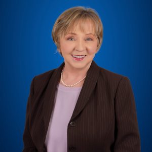 Suzanne Jacob headshot with blue background